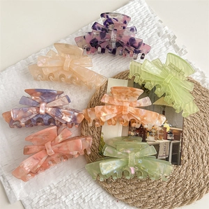 Elegant French bow hair claws in various acetate marble patterns and floral textures