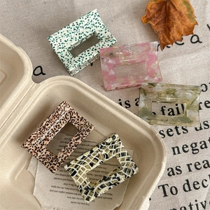 Chic rectangular cutout hair claws with handmade marble and polka dot acetate patterns