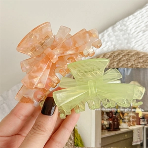 Elegant bow hair claw clips with marble texture and glitter finish for women
