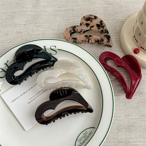 Set of five elegant heart-shaped acetate hair claws in assorted glossy patterns and colors