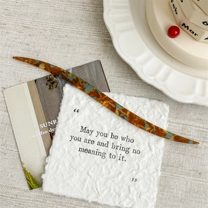 Detail showing the tortoise shell marble texture of a handmade French acetate hair pin