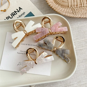 Set of four butterfly bow hair clips with elegant marble patterns and golden alloy frames