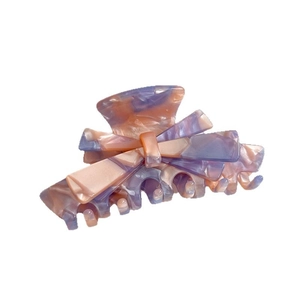 Elegant bow-shaped acetate hair claw clip with purple and orange marble texture patterns