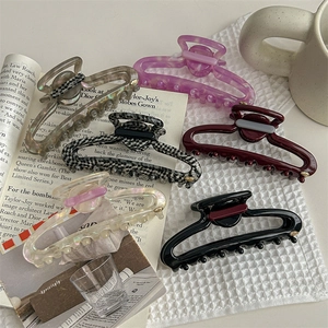 Hollow oval hair claw clips in assorted acetate patterns for thick hair styling