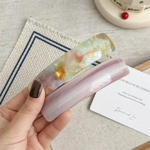 Elegant marble acetate hair clips set with multi-color and lilac patterns on soft background