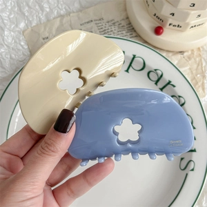 Cute cream and hazy blue floral hair claws with hollow design and French lettering