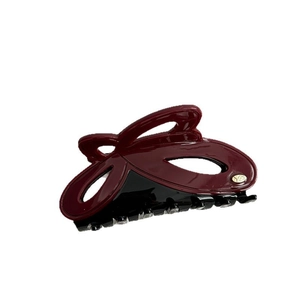 Dual-tone burgundy and black acetate hair claw clip with elegant bow-shaped design