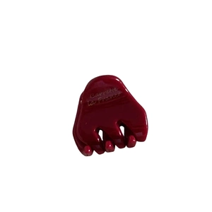 Deep red acetate hair clip with Barrette La France engraving on a clean white background