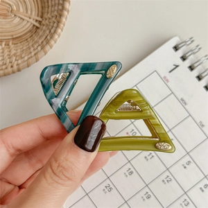 Minimalist acetate triangle hair clips with marble texture and gold metal logo
