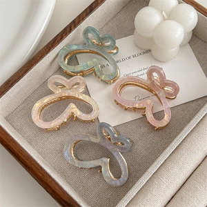 Set of 4 gradient butterfly hair claws with pearlescent finish and hollow design