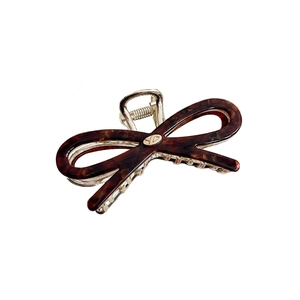 Elegant tortoiseshell acetate bow hair claw clip with golden metal spring and round logo
