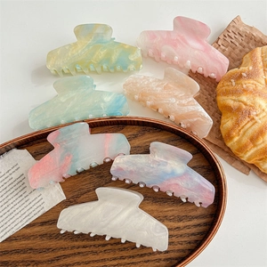 Elegant large marble textured acrylic hair claw clips in assorted pastel colors