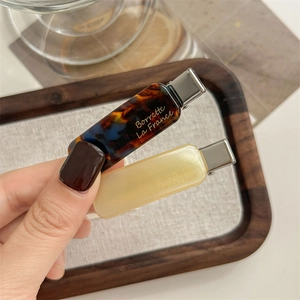 Elegant tortoise shell and cream acetate hair clips set with gold lettering for women