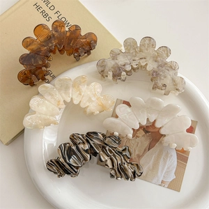 Floral pattern acetate hair claws in various marble colors for elegant hair styling