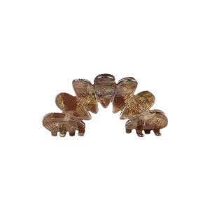 Polished amber tortoiseshell claw clip with acetate finish and sturdy flower petal design