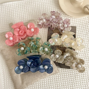 Floral claw clips with faux pearls in multiple colors including pink and blue marble finish