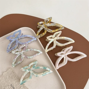 Elegant butterfly acetate hair claws in various marble textures and pastel colors