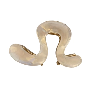 Elegant wavy acetic acid hair claw clip in creamy pearl finish with gold metal teeth