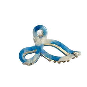 Elegant blue marble bow hair claw clip with golden metal teeth and YD logo detail