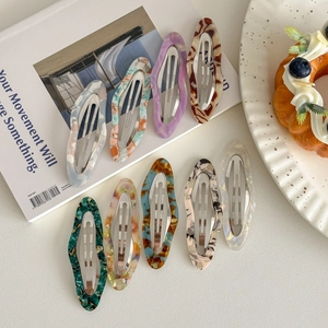 Cloud-shaped wavy acetate oval hair clips set in artistic marble and amber patterns