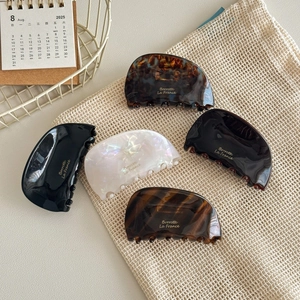 Set of vintage acetate hair claws in various patterns like tortoiseshell and marble