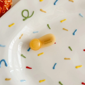 Close-up of amber resin hair clip featuring France Handmade engraving and glossy finish