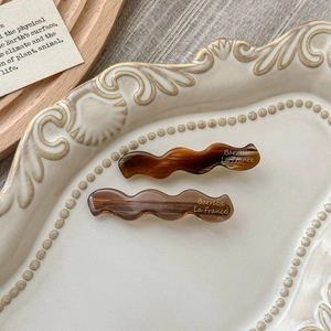 Detail of tortoise shell and amber wave hair clips with Barrette La France engraving