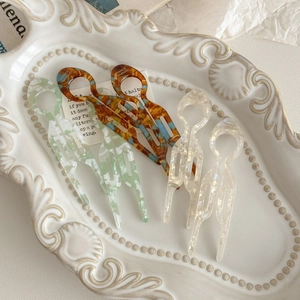 Elegant acetate hair pin in tortoise and mint patterns for stylish bun hair styling