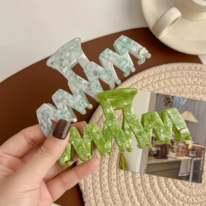 Set of two wavy marble green acetate shark hair claws with elegant metal logo detail