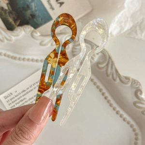 Elegant U-shaped acetate hair pins in tortoiseshell and pearly white finishes