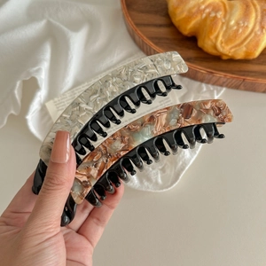 Double-toothed acetate banana hair clip in tortoiseshell and pearly white finish