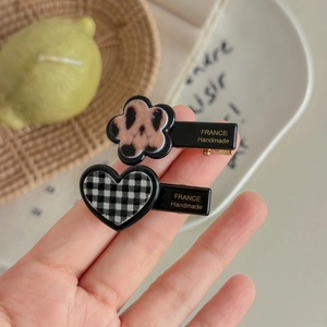 Leopard flower and checkerboard heart hair clips set in elegant black finish