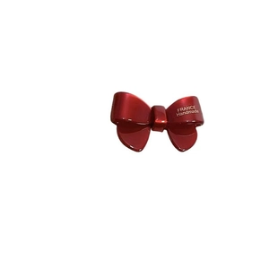 Handmade red acetate bow hair clip for women with France lettering on white background