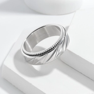 Close-up of 8mm silver spinner ring featuring punk mesh texture and rotating gears