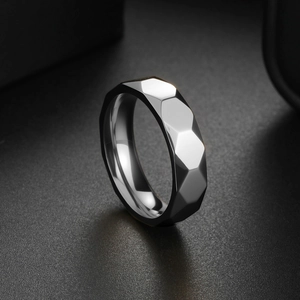 Men's titanium steel ring with hexagonal facets and a polished grey metallic finish