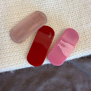 Vintage oval acetate hair clips in purple, red, and pink colors with France branding