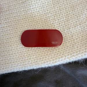 Vintage oval dark red acetate hair clip with silver Creation France lettering on fabric