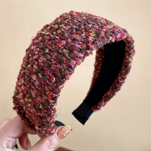 Detail of a thick French retro pink tweed headband showing rich knitted texture and pattern