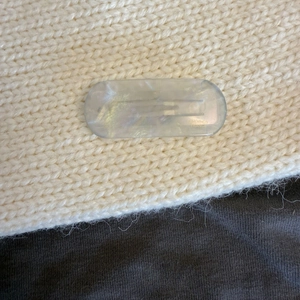 Macro shot of iridescent blue acetate hair clip featuring the Creation France engraving