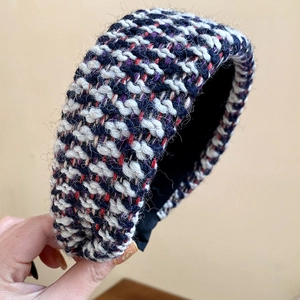Detailed macro view of wide padded tweed knit headband with multi-color texture
