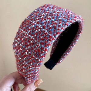 Detail of red and blue tweed wide headband showing luxury textured fabric and inner grip
