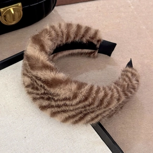 Gros plan du serre-tête en peluche léopard avec fausse fourrure et doublure satin