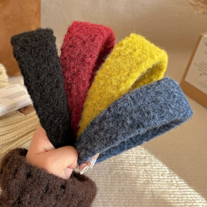 Set of four thick knitted felt headbands in black, red, yellow, and blue colors