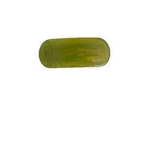 Retro grass green acetate hair clip featuring white Creation France lettering on a white background