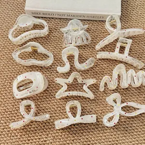 Elegant cream hair claw clips set with colorful rhinestones in star and bow shapes