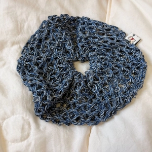 Close-up of blue and white hollow crochet oversized hair scrunchie with woven label detail