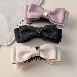 Elegant wool bow hair clips with gold heart charms in pink, grey and beige colors