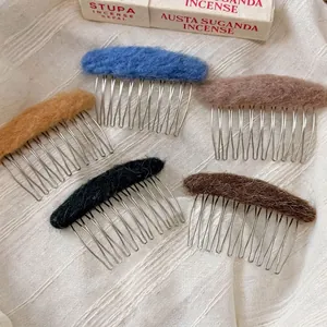 Five-piece set of oval felt metal hair combs in assorted pastel colors on white fabric