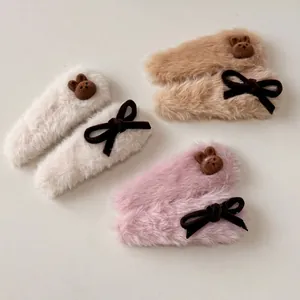 Three pairs of plush bear and bow hair clips in beige, khaki, and soft purple colors