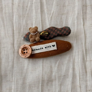 Detailed shot of cute plaid bear hair clip and corduroy button hairpin set for women